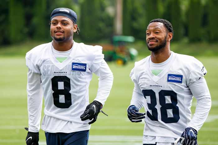 Jun 7, 2022; Renton, Washington, USA; Seattle Seahawks cornerback Coby Bryant (8) and cornerback Josh Turner (38) jog to the locker room following minicamp practice at the Virginia Mason Athletic Center Field. Mandatory Credit: Joe Nicholson-USA TODAY Sports